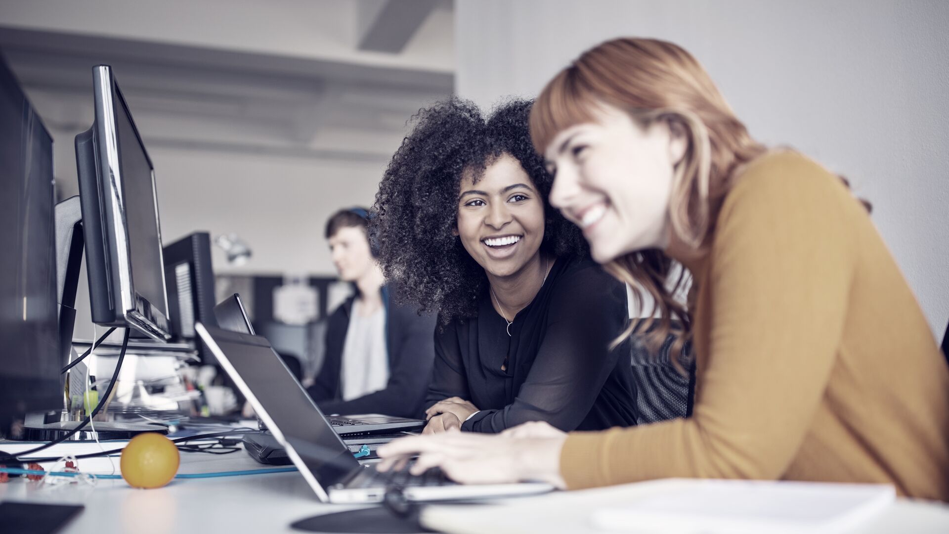 Two female colleagues in office working together