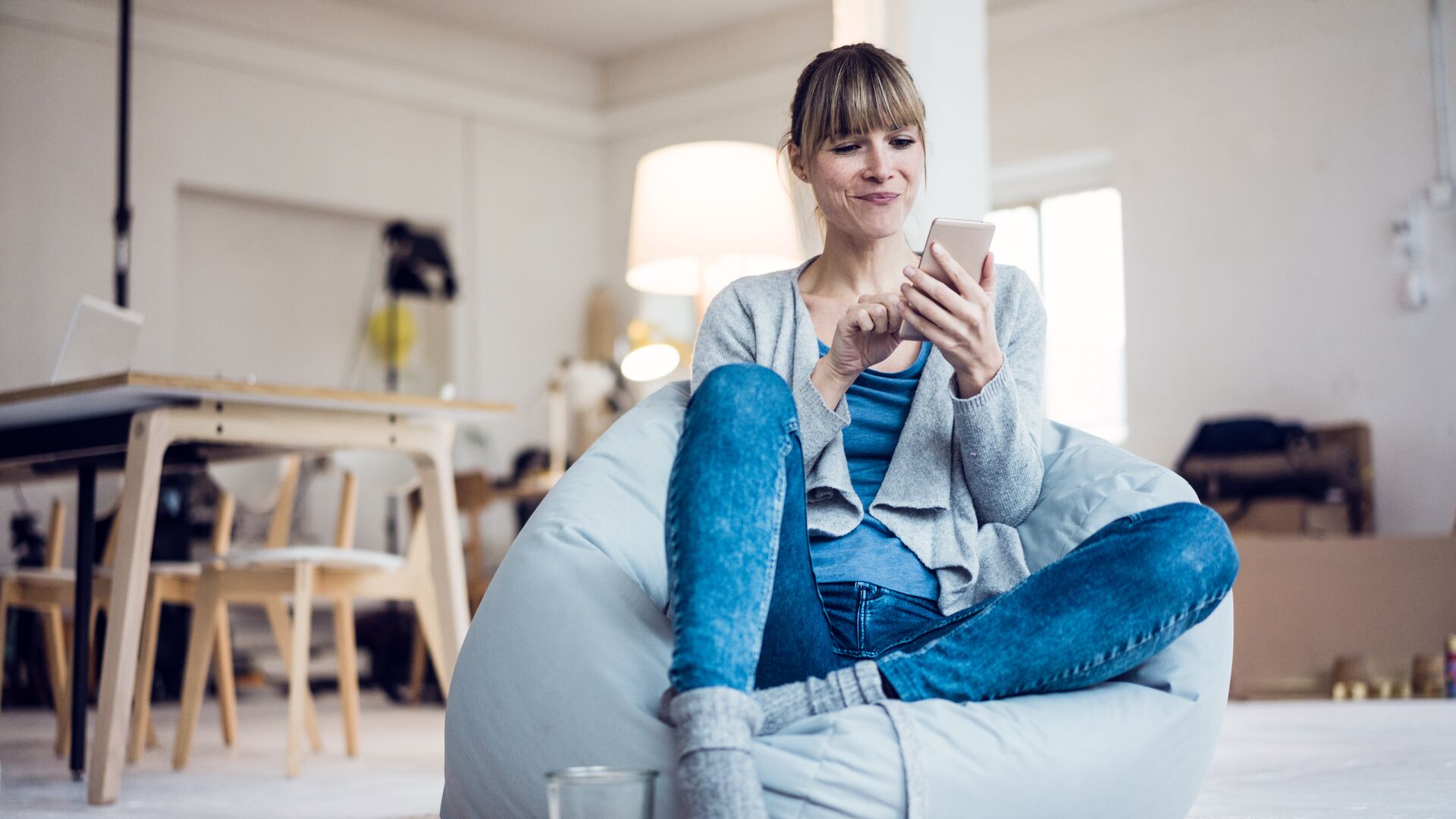 Relaxed woman using phone