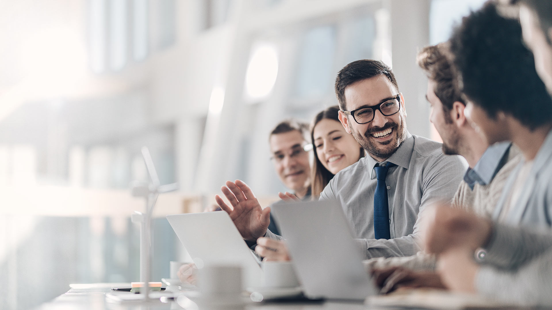 Group of people smiling at business meeting