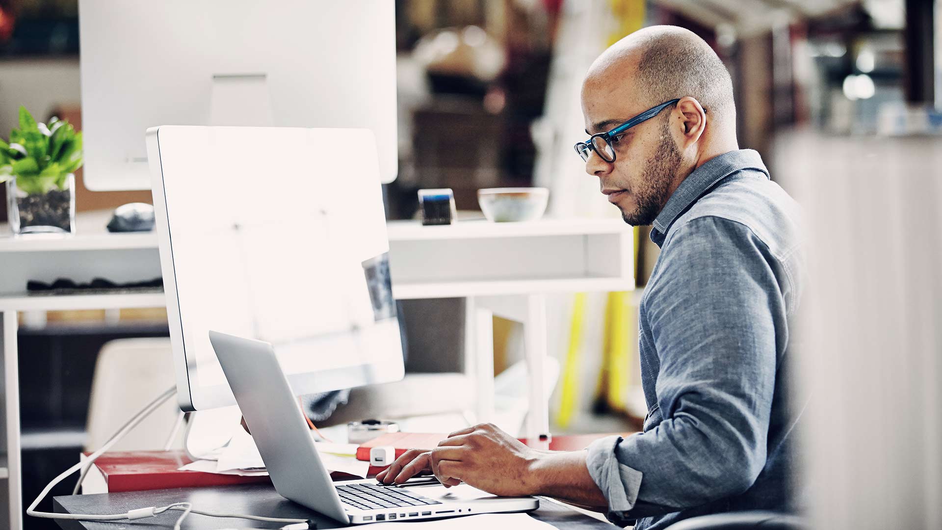 Man working on computers in a modern office