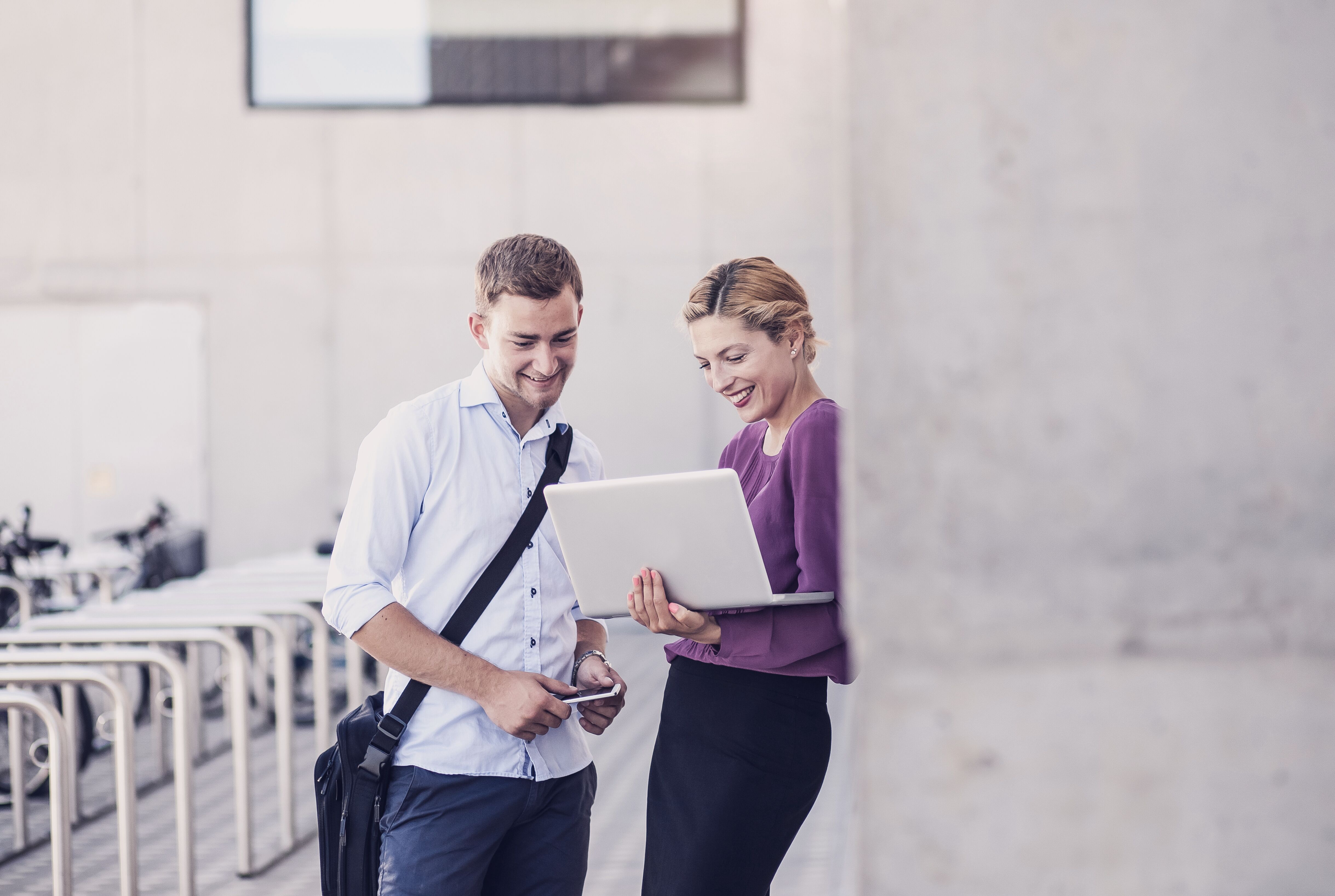 Two people looking at a laptop