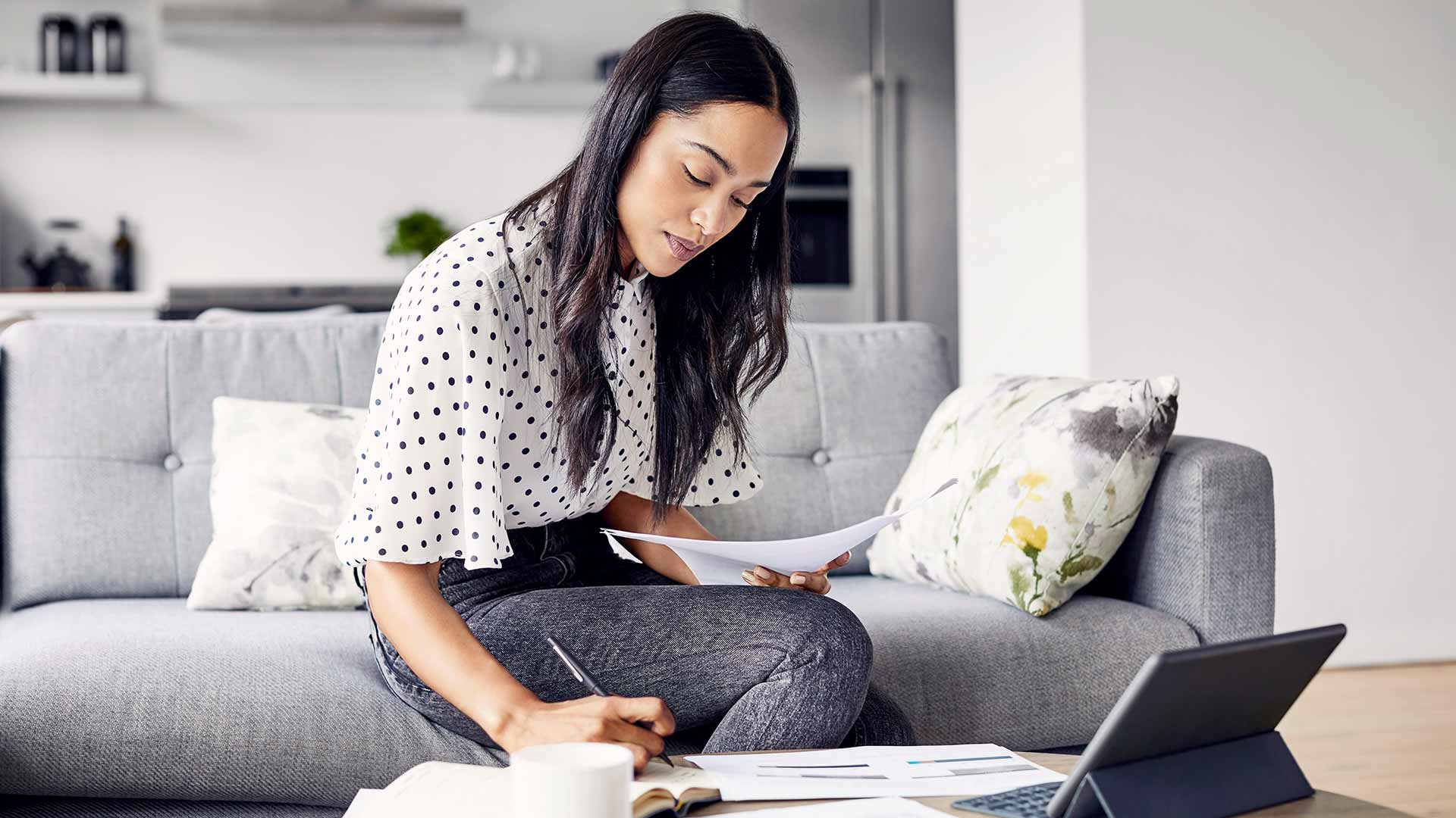 Woman in home office taking notes
