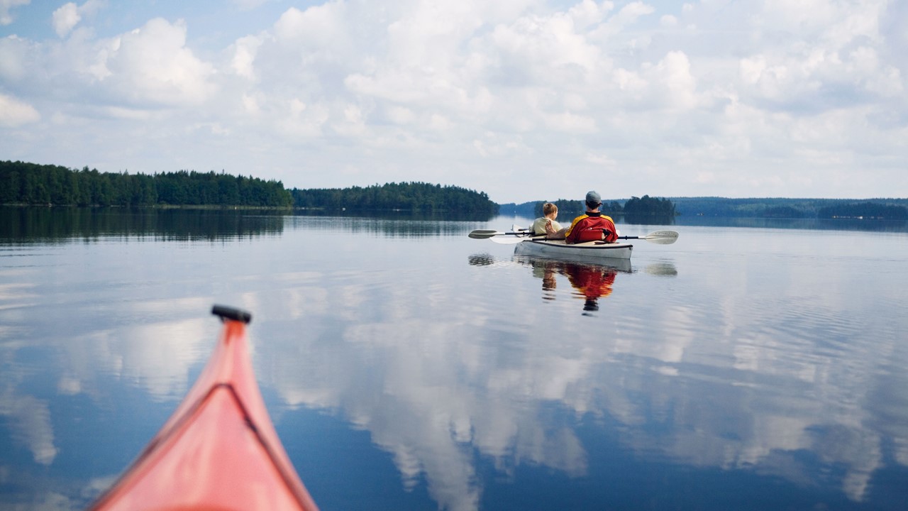 Family on canoes in lake 