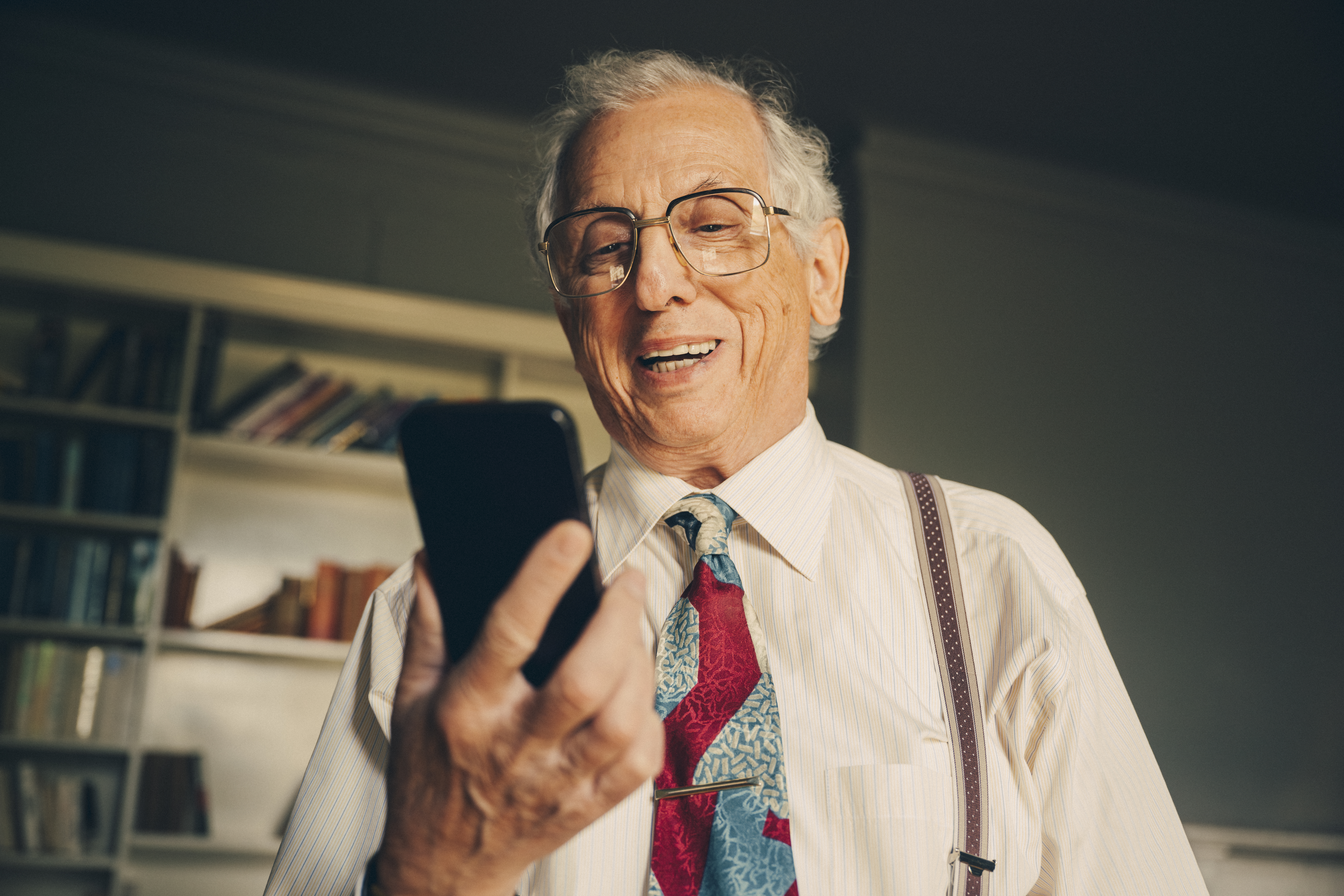 Happy senior man with mobile phone