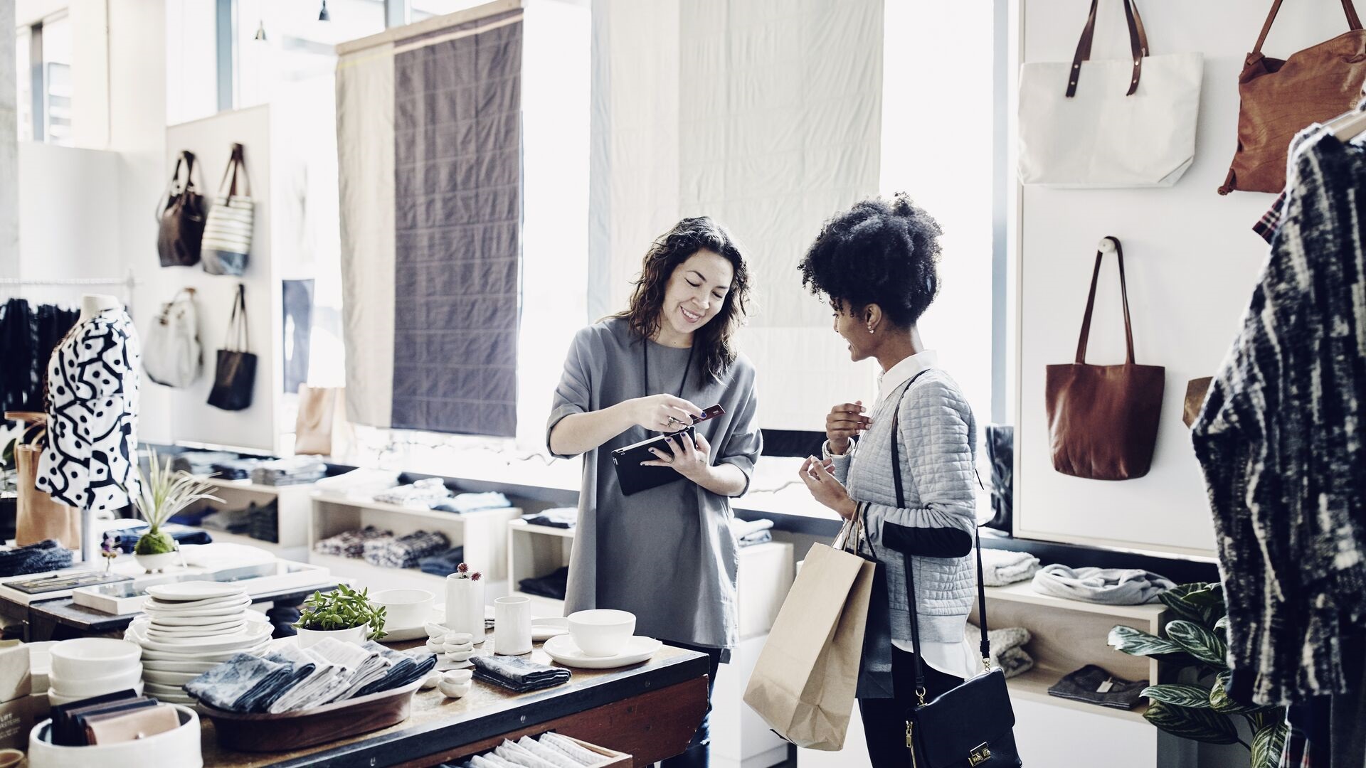 Two people processing payment in shop