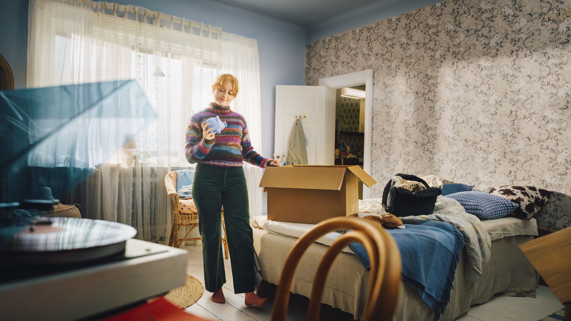 Girl in teenage room moving out