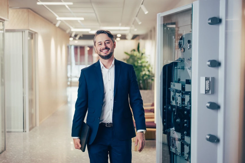 Man walking and smiling at the office hallway