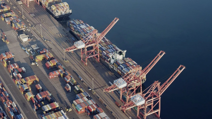 Containers and cranes in industrial shipyard