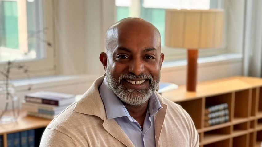 man sitting down smiling