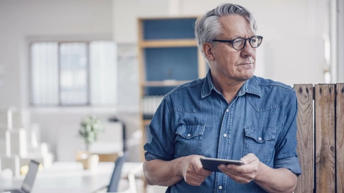 Senior man holding tablet