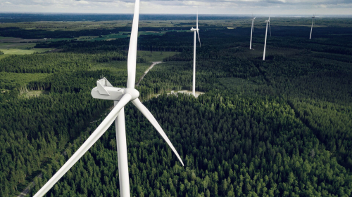 Aerial view of windmills in summer forest in Finland