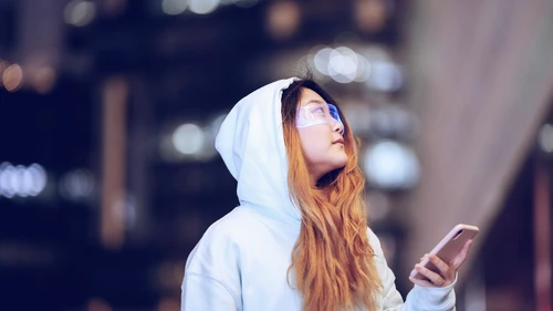 Women looking at mobile with smart glasses