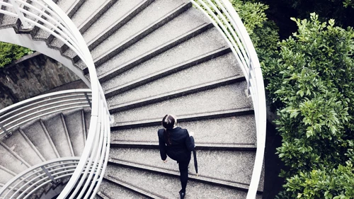 Business woman walking up some stairs