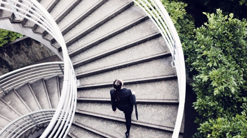 Business woman walking up some stairs