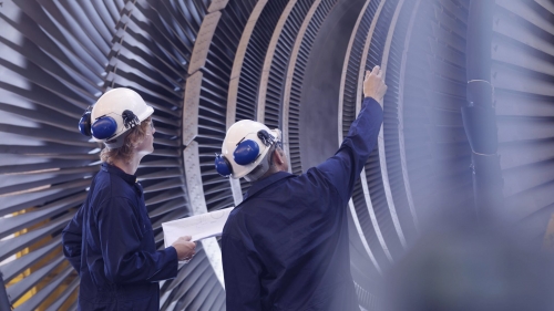 Engineers looking at turbine