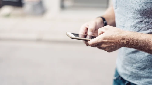 Close-up of man holding phone