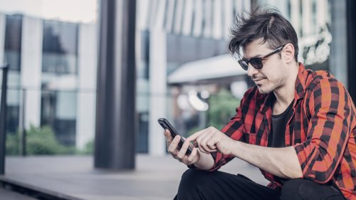 man-with-glasses-looking-at-phone