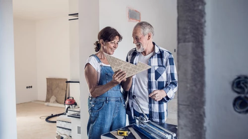 senior-couple-laying-tile-floor-in-new-home