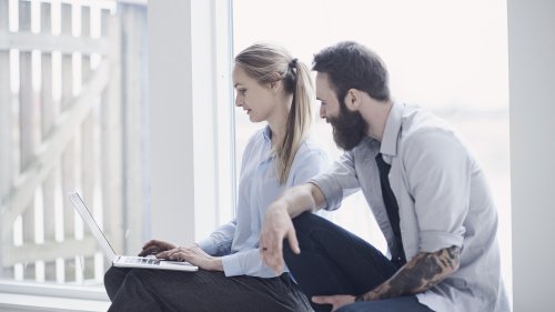 Woman and man looking at laptop