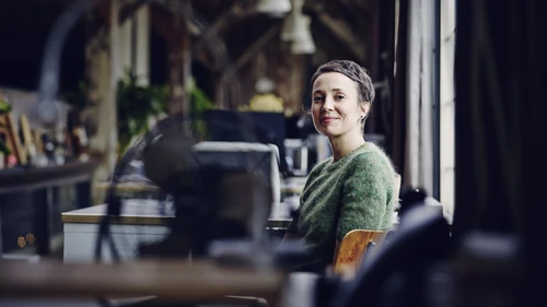 Smiling woman sitting at a desk in modern office