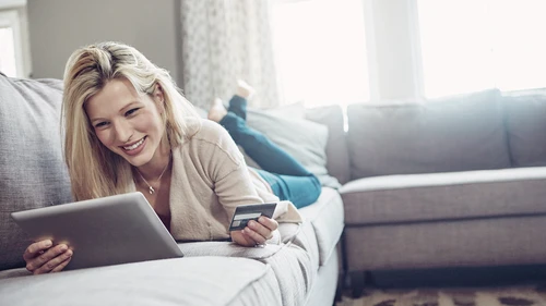 women on sofa paying 