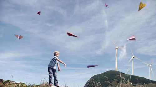boy-playing-with-paper-planes