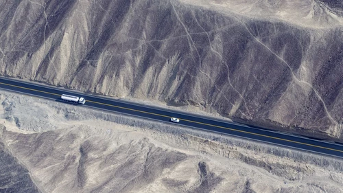 Aerial view of truck driving through desert