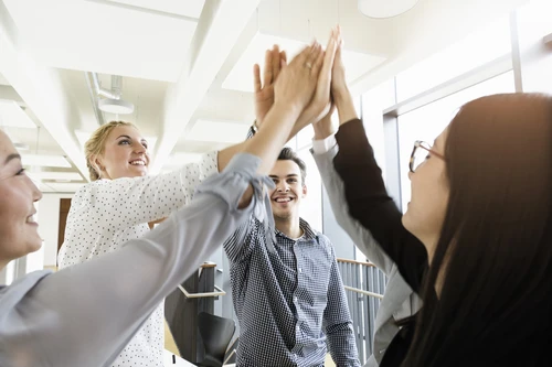 Colleagues celebrating in an office
