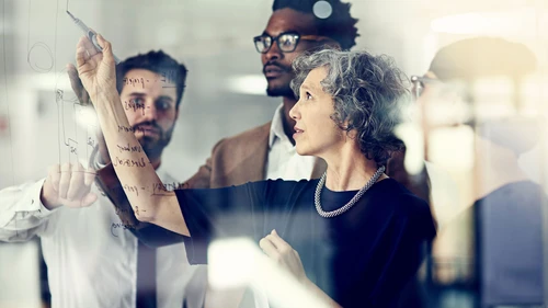Colleagues in front of glass wall