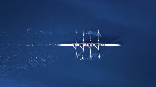 Rowing boat surrounded by classic blue water