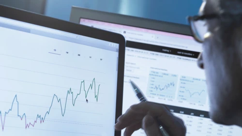 Stock analyst researching share price data graph