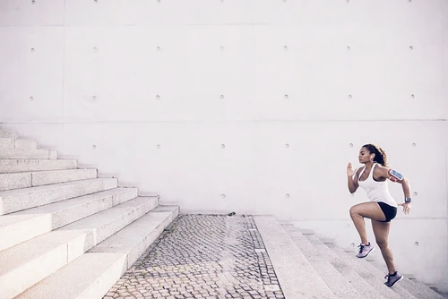 Woman running up the stairs