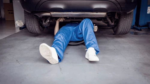 Auto mechanic working on a car