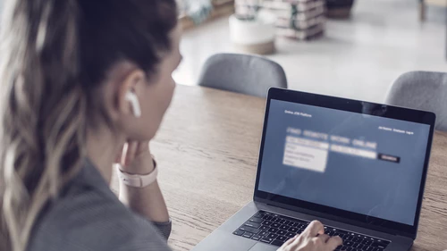 Woman logging on to online meeting