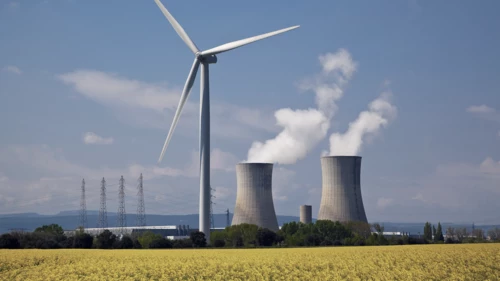 Nuclear power plant behind a windmill