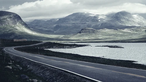 Road-next-to-sea-and-mountains