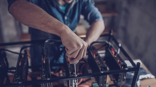 Guy configures the computer for mining cryptocurrency