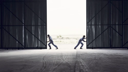 Teamwork pushing barndoors open