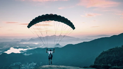 Paraglider taking off from mountain