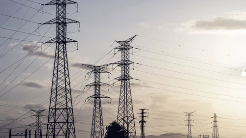 Silhouettes of a group of high-voltage electric towers