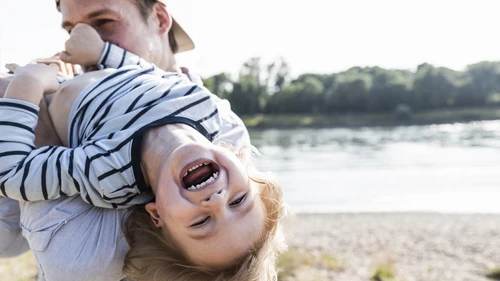 Father playing with laughing child