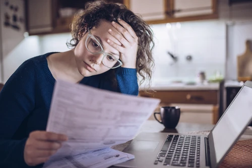 Worried woman watching bills