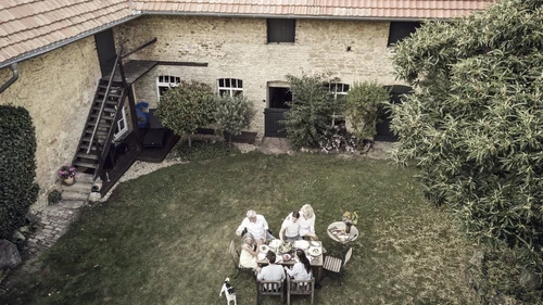 Family eating together in the garden in summer