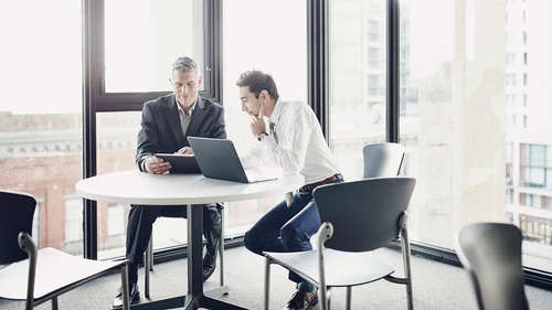 Businessmen reviewing data on digital tablet