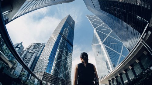 Businesswoman standing against contemporary financial skyscrapers