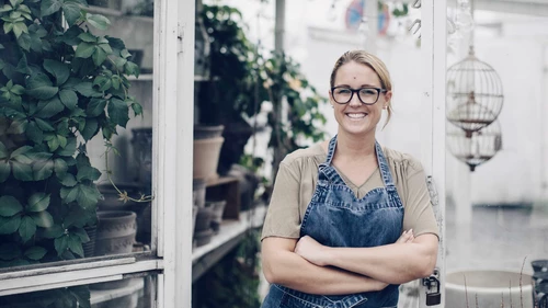 Woman standing in her garden shop