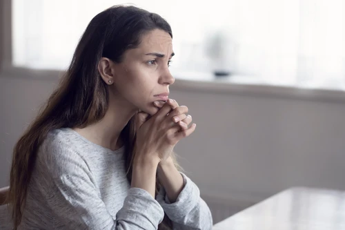 Young woman looks into the distance.
