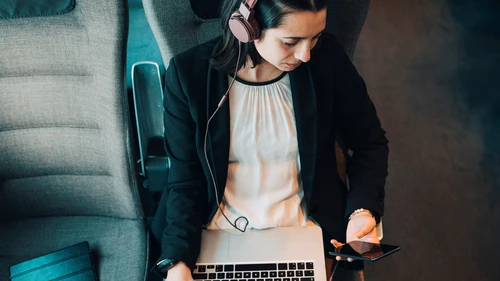 women-sitting-on-train-checking-her-phone.jpg