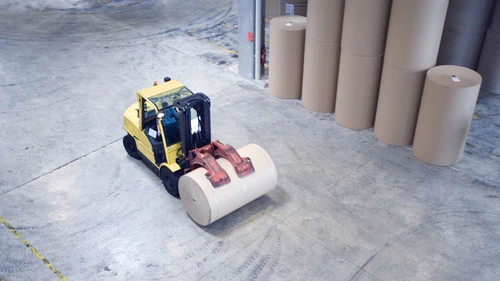 Fork lift picking up roll of paper