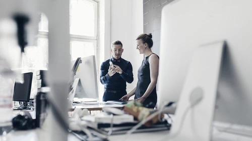 person-showing-phone-to-another-person-in-an-office.jpg